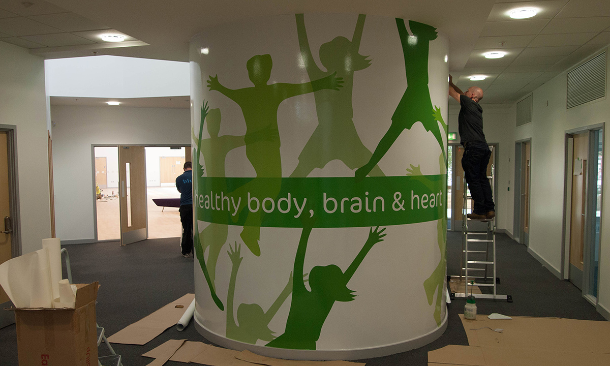Lime Tree School Signage - Installing vinyl graphics to the surface of the Pod