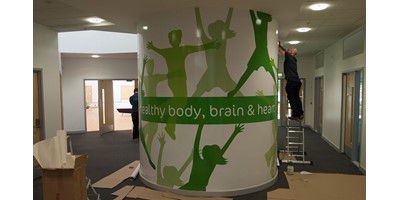 Lime Tree School Signage - Installing vinyl graphics to the surface of the Pod
