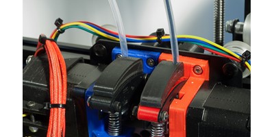The MendelMax 3 3D printer - Filament tube guides fitted to the existing extruder assemblies